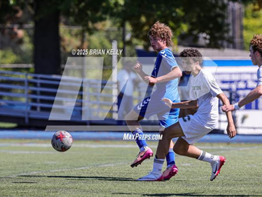 canton high school soccer players kick the ball