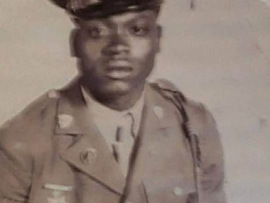 Black-and-white portrait of a young man in a military uniform and cap