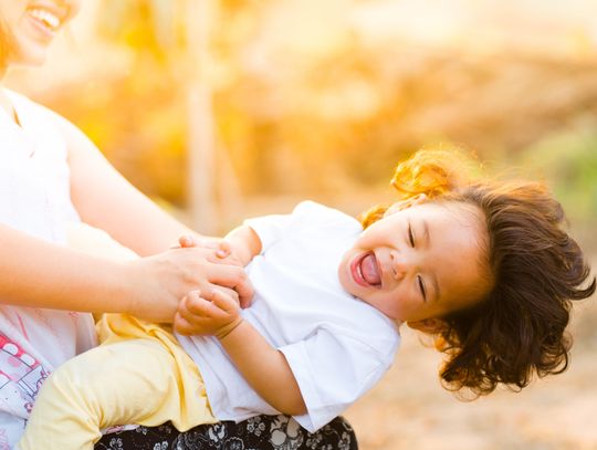 woman holding a baby smiling