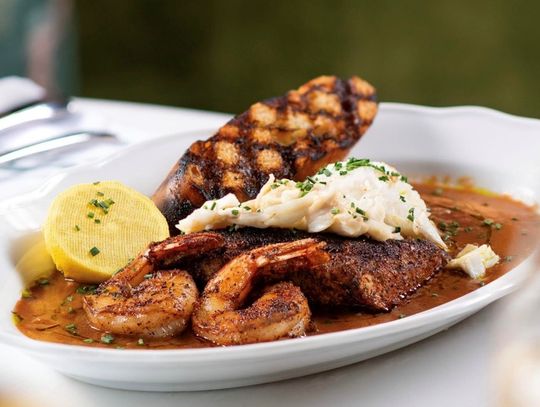 Coraline’s Redfish Court Bouillon is a delectable dish of fresh seafood prepared with New Orleans-inspired flair and flavors.