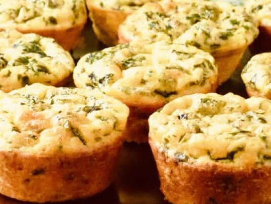 Hearty egg muffins filled with spinach and cheese (or favorite protein like bacon or ham) are easy to eat on the go and are a healthy breakfast option.