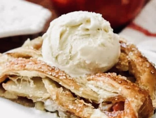 A slice of apple strudel topped with a scoop of vanilla ice cream is the perfect fall treat.