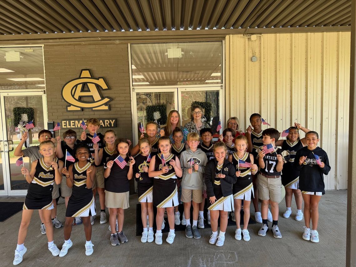 DAR members help fourth graders celebrate Constitution Day Fourth-grade students in matching school shirts hold small American flags during a Constitution Day visit