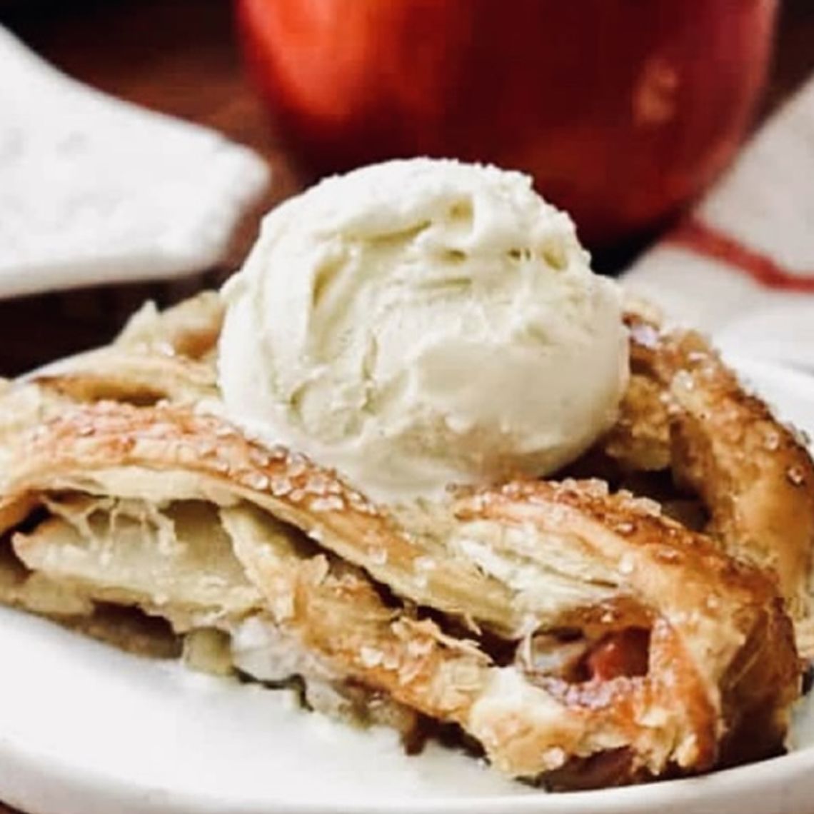 A slice of apple strudel topped with a scoop of vanilla ice cream is the perfect fall treat.