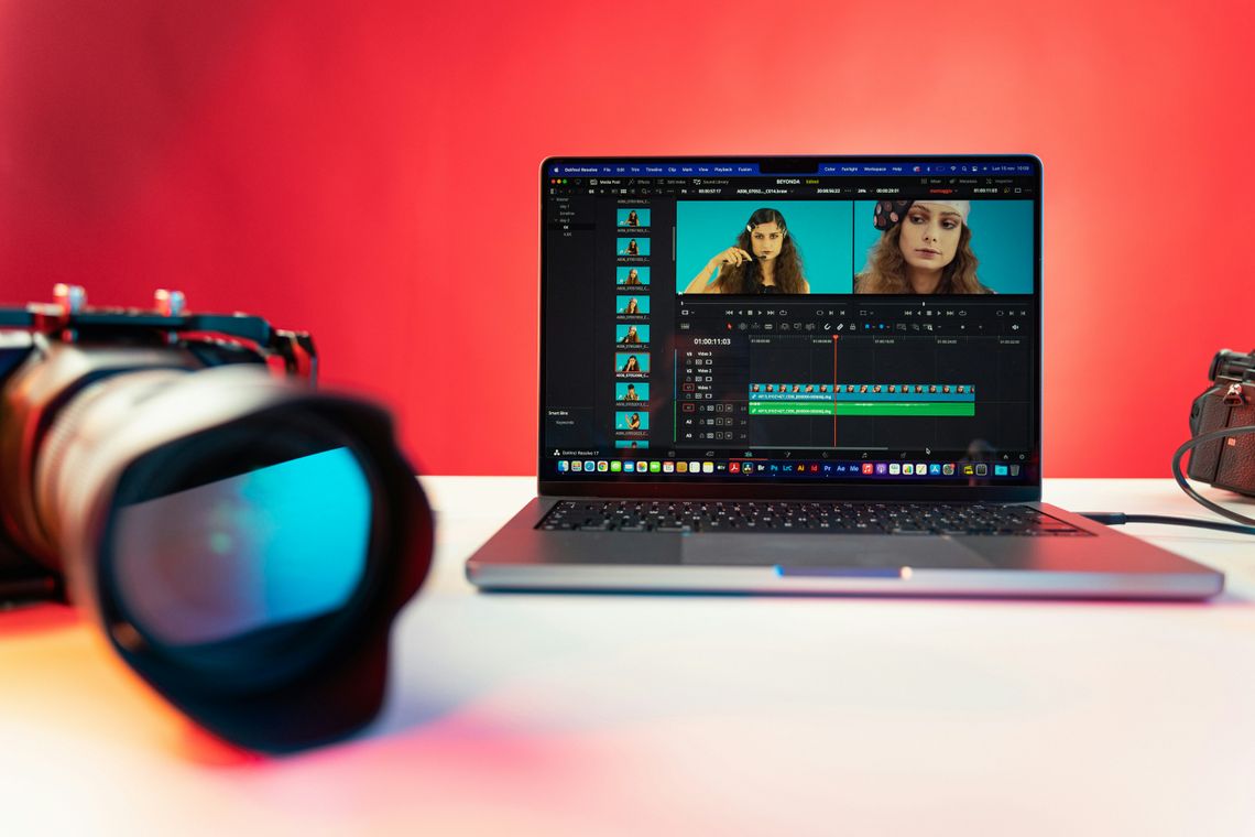 The Future of Video Editing: The Collision of AI Technology and Human Creation laptop and camera sitting on a desk with video editor